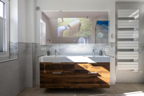 een badkamer met een wastafel en een spiegel bij Ferienhaus Veronika an der Üselitzer Wiek in Mellnitz