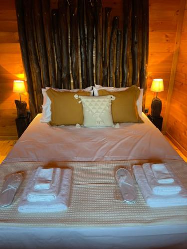 a large bed with two sets of towels on it at Luxury Wooden Villas in Makrygialos