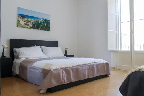 A bed or beds in a room at M&M Apartment