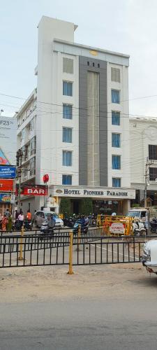 a hotel with cars parked in front of a building at HOTEL PIONEER PARADISE in Nāgercoil