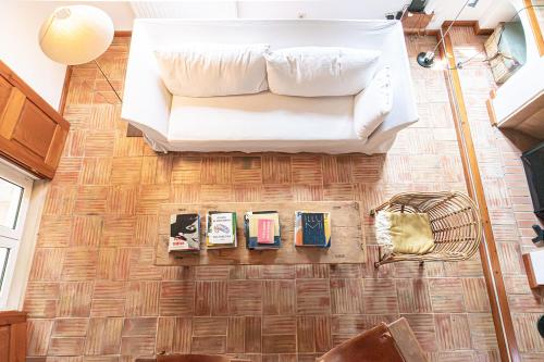 a living room with a white couch on a wooden floor at Casa Oleandra in Melides