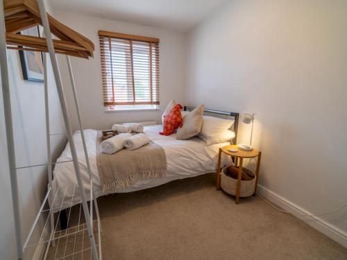 a small bedroom with a bed and a window at Pass the Keys Beautiful Nottingham home with Private Driveway in Nottingham