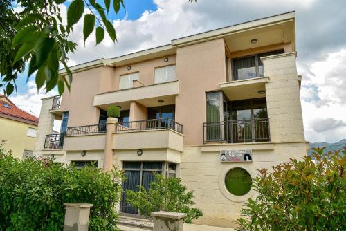 a building with balconies on the side of it at Apartment Madonna in Dugopolje
