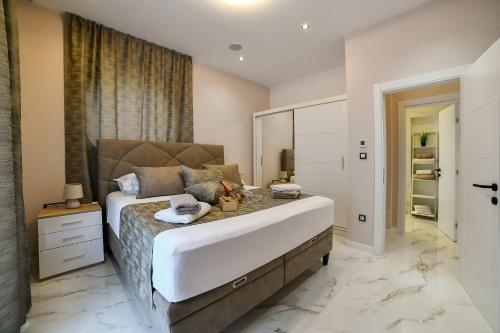 a large bedroom with a large bed and a mirror at Apartment Madonna in Dugopolje