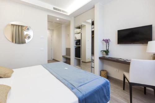 a bedroom with a bed and a desk and a television at Villa Cavalletti in Grottaferrata