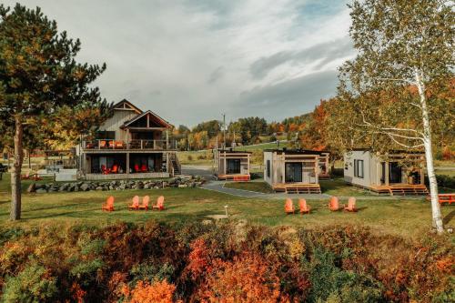 a house in the woods with orange cones in the yard at Le 2800 du Parc in Shawinigan