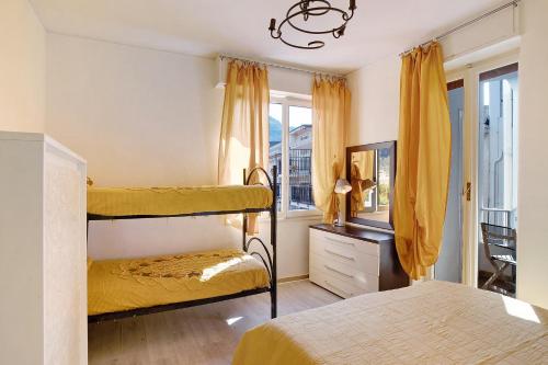 a bedroom with two bunk beds and a mirror at Rosina's house in Ventimiglia