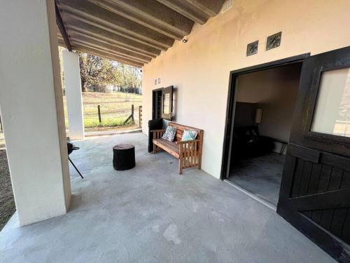 a garage with a door open to a patio at The Stables in Roodepoort
