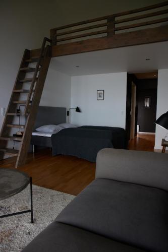 a living room with a bunk bed and a couch at Langhoff & Juul Boutique Hotel og Restaurant in Ebeltoft