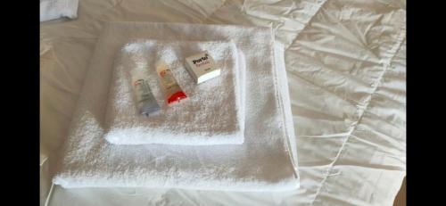 a bed with two items wrapped in plastic on it at Executive Royal Tower Apartments - Sky Lounge in El Alamein