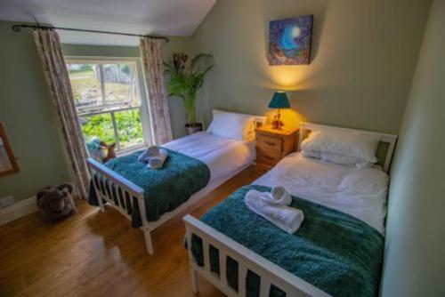 a bedroom with two beds and a window at Moor View in Lockton