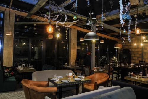 a restaurant with tables and chairs and lights at Cuib Complex Turistic in Căpriana