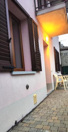 a building with a window and a chair on a patio at Ristorante Bellavista con Locanda in Veleso