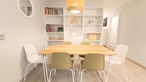 a dining room with a wooden table and chairs at Amplio y cómodo apartamento. in Granadilla de Abona