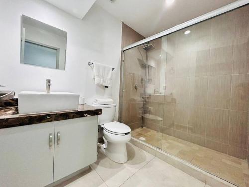 a bathroom with a shower and a toilet and a sink at pie de playa y con vista al mar by G P S rentas in Mazatlán