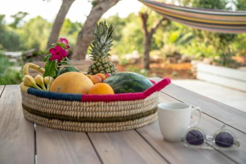 a basket of fruit sitting on a table with a cup at Mourelo Home in Gavalochori