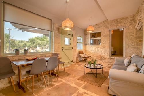 a living room with a couch and a table at Mourelo Home in Gavalochori