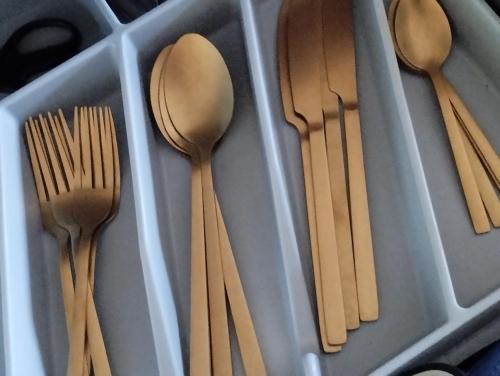 a group of wooden spoons and forks in a drawer at PERIGIALI APARTMENT in Kavála