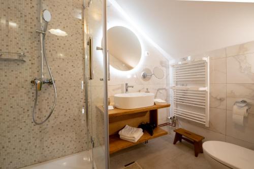 a bathroom with a sink and a shower at Eco Tourist Farm Ravnjak in Slovenj Gradec