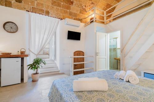 a bedroom with a bed with towels on it at Le Antiche Dimore di Cadia in Ugento
