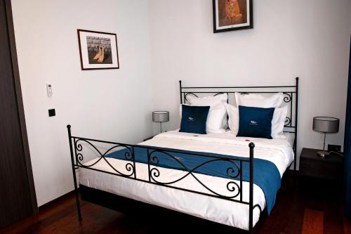 a bedroom with a bed with blue and white pillows at Botanique Suites AirBnB, Antwerp in Antwerp