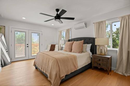 a bedroom with a bed and a ceiling fan at Lux Lake Travis in Austin