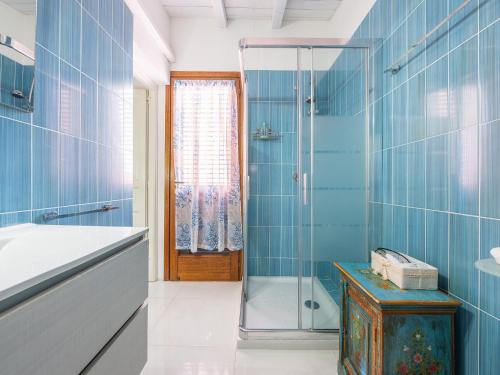 ジェレメアスにあるKala Nostraの青いタイル張りの壁のバスルーム(シャワー付)