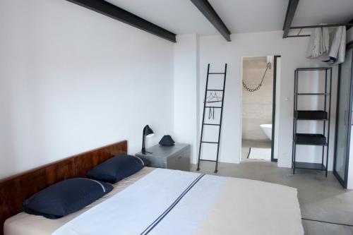 a bedroom with a large bed and a bathroom at Sisters-Homes Vidovići 9 in Martinšćica