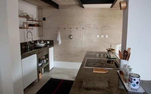 a kitchen with a counter and a stove top oven at Sisters-Homes Vidovići 9 in Martinšćica