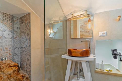 a bathroom with a glass shower and a sink at Le Antiche Dimore di Cadia in Ugento