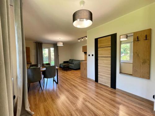 a living room with a table and a dining room at Apartamenty MarSyl in Jastrzębia Góra