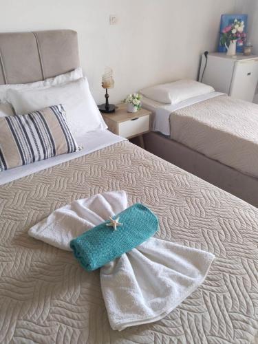 a bedroom with two towels on a bed at Notos Rooms in Loutro
