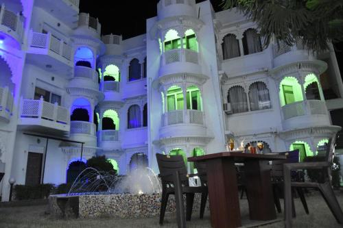 a building with blue and green lights on it at Shree Ji Resort in Nāthdwāra
