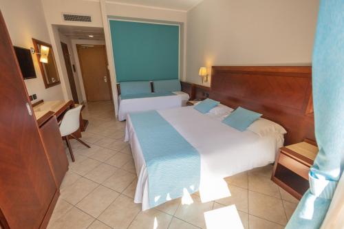 Letto o letti in una camera di Hotel Le Palme