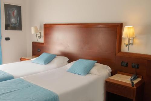 Letto o letti in una camera di Hotel Le Palme