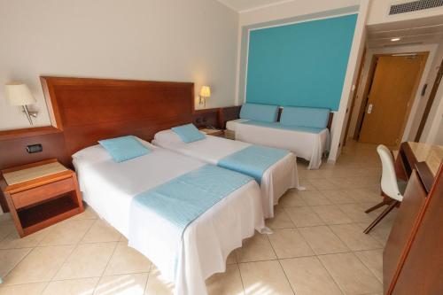 Letto o letti in una camera di Hotel Le Palme