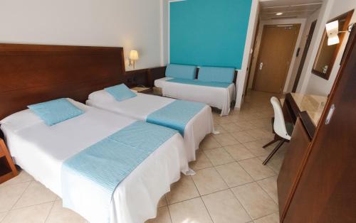 Letto o letti in una camera di Hotel Le Palme