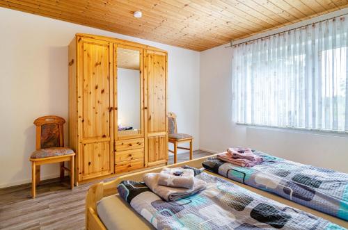 a bedroom with two beds and a large window at Carmen in Wald