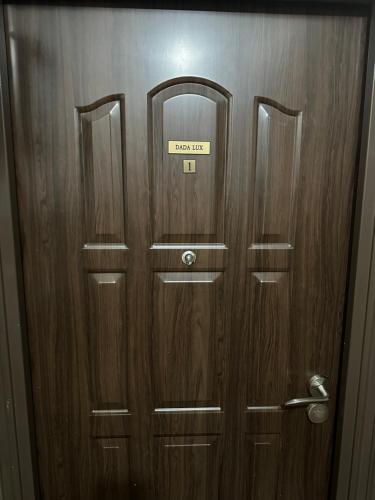 a wooden door with a sign on it at Dada Lux in Kumanovo