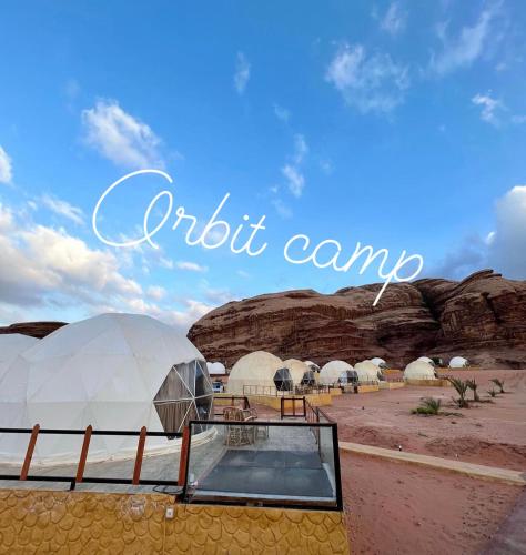 a group of domes in the desert with the words orbit camp at Orbit camp in Wadi Rum