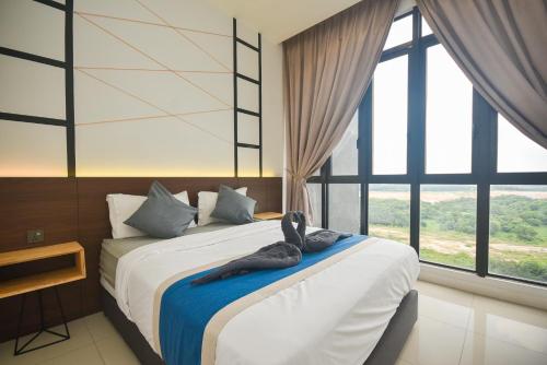 a bedroom with a bed with a towel on it at D'Pristine Theme Suite by Nest Home at LEGOLAND in Nusajaya