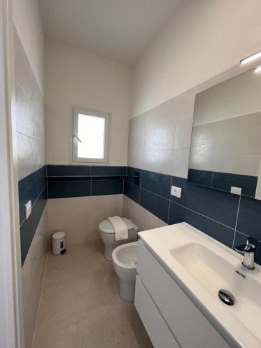a bathroom with a toilet and a sink at Villette di Cala Creta in Lampedusa