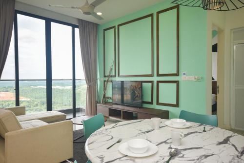 a living room with a table and chairs and a couch at D'Pristine Theme Suite by Nest Home at LEGOLAND in Nusajaya