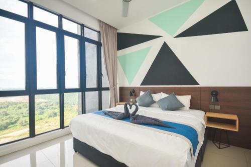 a bedroom with a large bed and large windows at D'Pristine Theme Suite by Nest Home at LEGOLAND in Nusajaya
