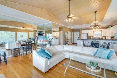 a living room with a white couch and a kitchen at Lake-View Balcony Hot Springs Penthouse! in Hot Springs