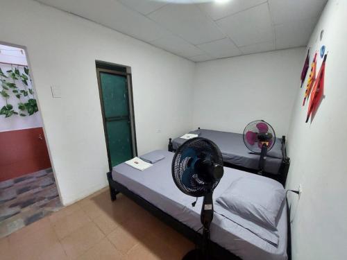 a room with a bed with a fan on it at apto #5 cómodo y acogedor en lugar estratégico in Ríohacha
