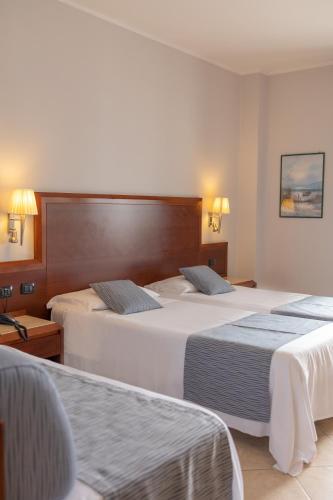 Letto o letti in una camera di Hotel Le Palme