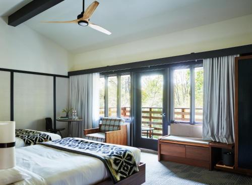 a bedroom with a bed and a large window at Skyline Lodge in Highlands