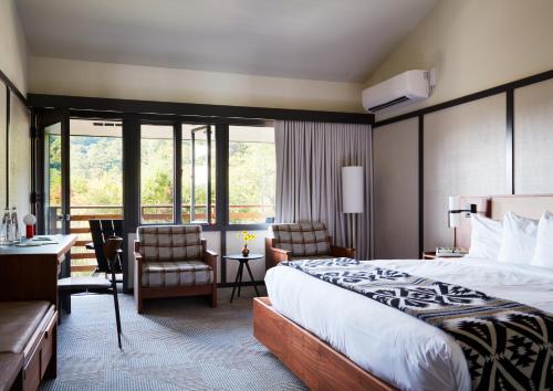 a hotel room with a bed and a desk and chairs at Skyline Lodge in Highlands