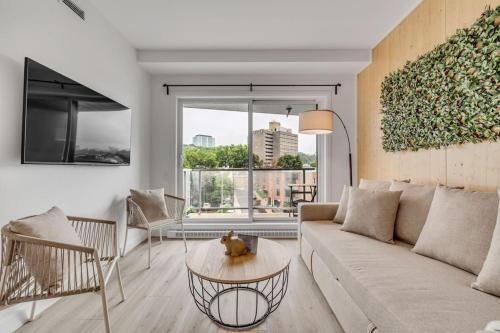 a living room with a couch and a table at Initial / Lapin / Downtown Qc in Quebec City